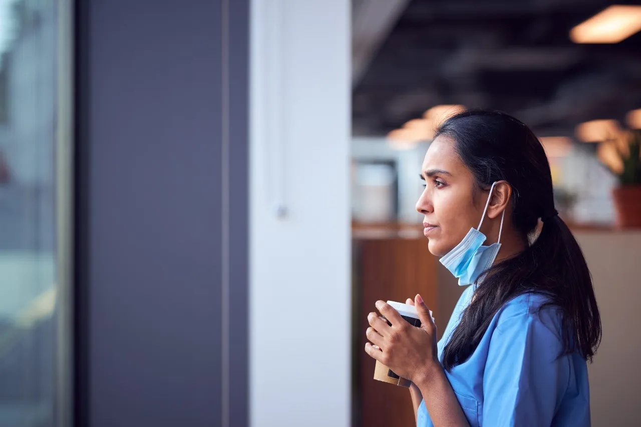 picture of a thoughtful nurse gazing out window